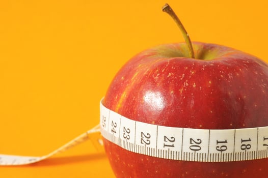 Red apple and a tape measure photo