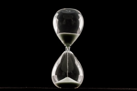 Hourglass on dark background photo