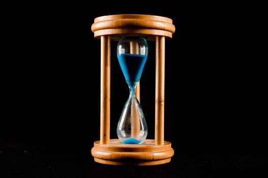 Hourglass on dark background photo