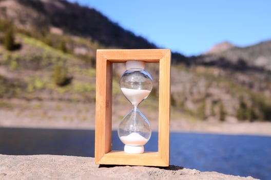 Hourglass on a rock photo