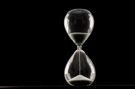 Hourglass isolated on black background photo