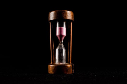Hourglass isolated on black background photo