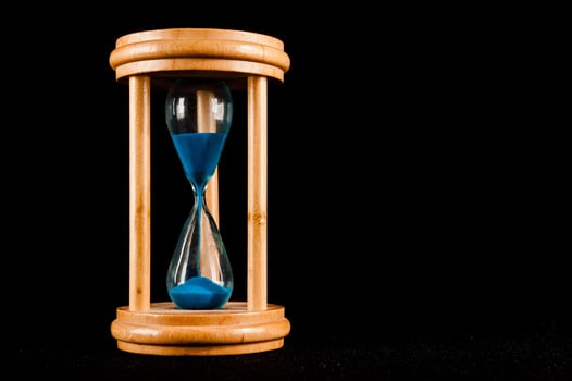 Hourglass isolated on black background photo