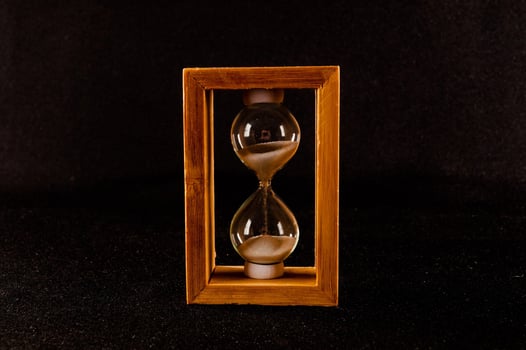 Hourglass on dark background photo