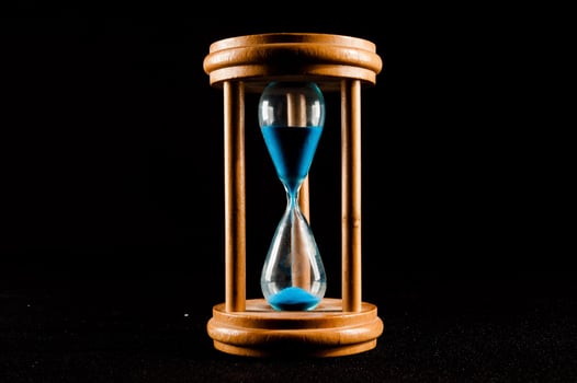 Hourglass on dark background photo