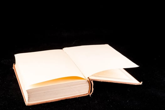 Open book on black backgrond photo