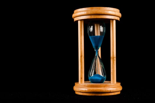 Hourglass on black background photo