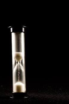 Hourglass on dark background photo