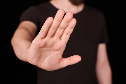 Man in black t-shirt doing stop sing photo