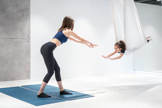 Mom and Daughter are doing yoga. Family in a gym. photo