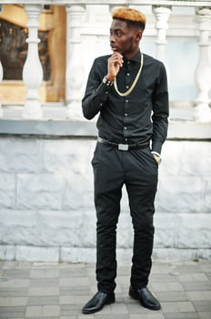 Chic handsome african american man in black shirt with gold chain. photo