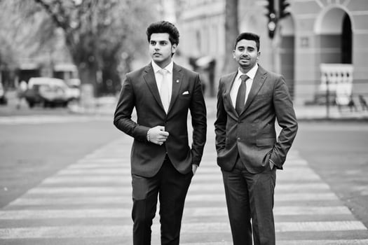 Two elegant indian fashionable mans model on suit walking at cross pedestrian. photo