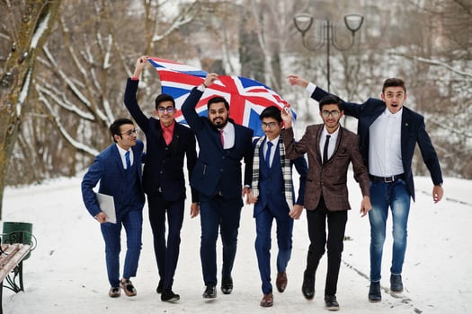 Group of six indian businessman in suits posed outdoor in winter day at Europe with flag of Great Britain. Friendly relations with India and UK. photo