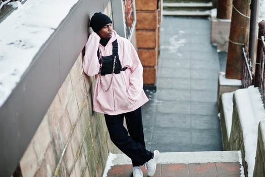 Stylish urban style african american man in pink hoodie posed at winter day. photo