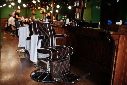 Brown vintage leather chairs at stylish barber shop. photo