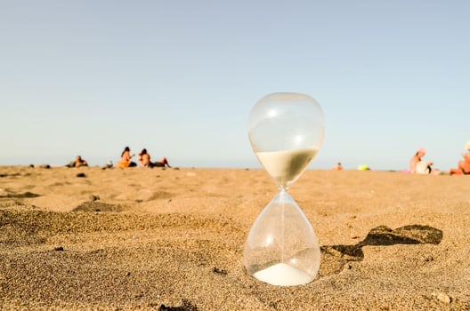 an hourglass on the beach with people in the background photo