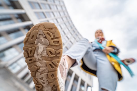 Close up of sneaker shoes of young woman on street photo