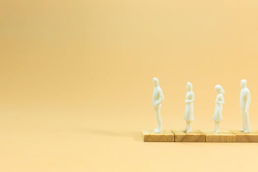 white  figure miniature on orange pastel for business content. photo