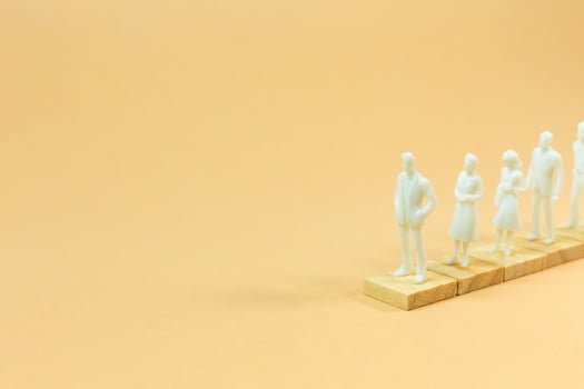 white  figure miniature on orange pastel for business content. photo