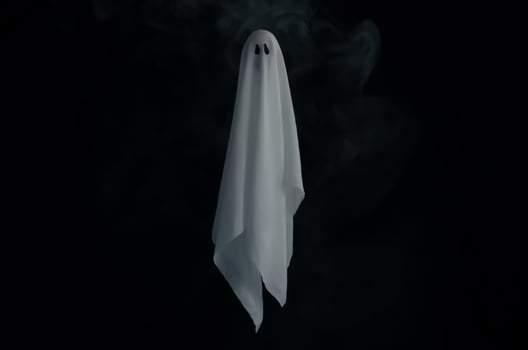Blurred focus of white ghost sheet in dark background with smoke. Halloween scary concept. photo