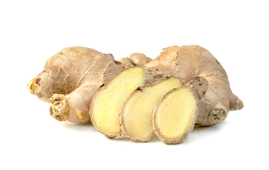 sliced fresh ginger root isolated on white background photo