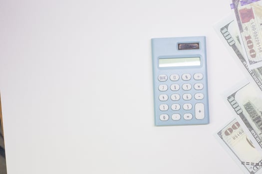 blue calculator and banknotes on white back ground. photo