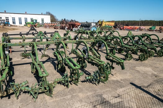 Parking agricultural machinery and harvest. rows of plows, cultivators, bodies photo