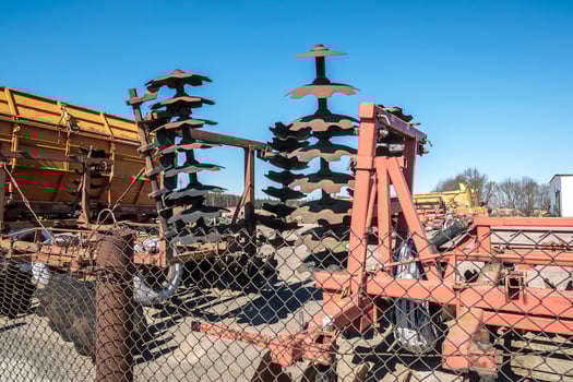 Parking agricultural machinery and harvest. rows of plows, cultivators, bodies photo