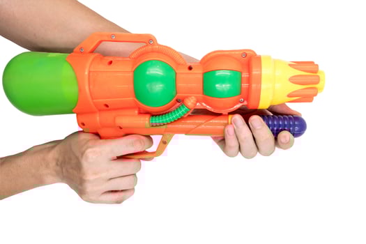 Hands holding gun water toy on white background. photo