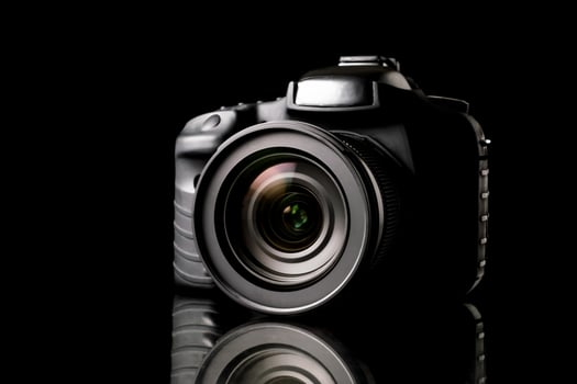 Digital camera on black background. photo