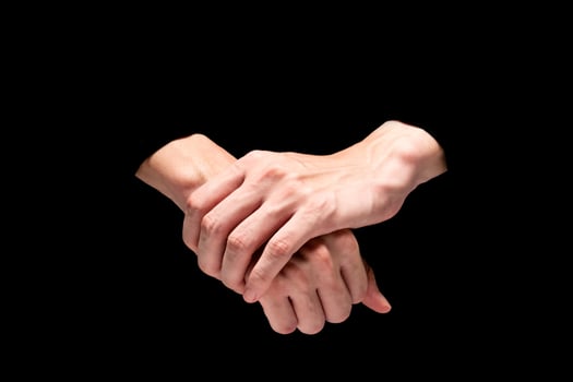 Male hands on a black background. photo