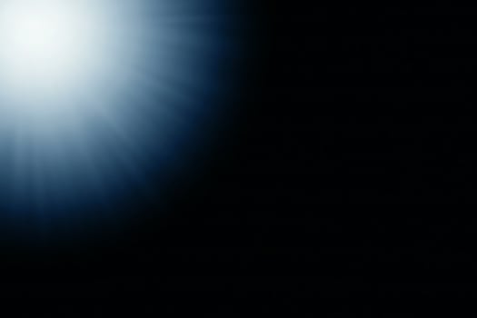 Blurred blue abstract light rays on a black background. photo
