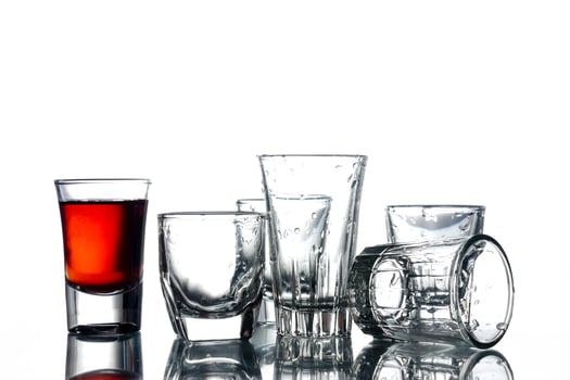 Collage of glasses with alcohol on a white background. photo