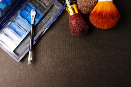 Makeup brushes and palette on black background, Free space for text. photo