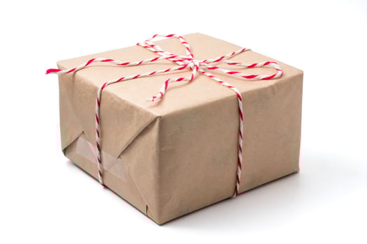 Gift package wrapped in brown paper on white background. photo