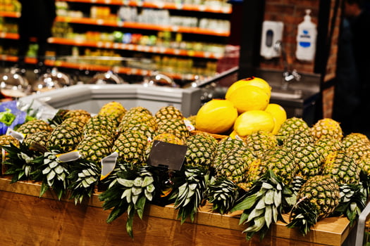 Pineapple on boxes at supermarket for sale. photo