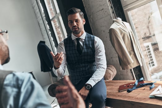 Long working day. Two young fashionable men having a discussion while spending time in the workshop photo