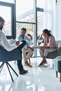 Giving good advice. Young married couple talking while sitting on the therapy session with psychologist photo