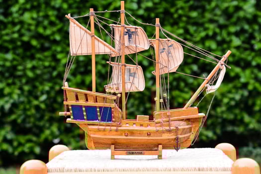 a wooden model of a pirate ship on a table photo