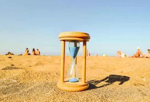 A hourglass on the sand photo