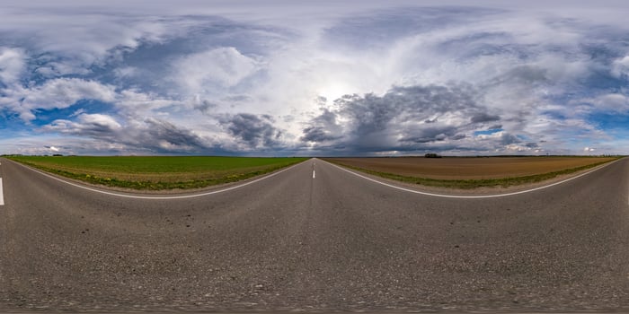 Full spherical seamless hdri panorama 360 degrees angle view on no traffic asphalt road among fields in evening before sunset with cloudy sky. 360 panorama in equirectangular projection, VR AR content photo