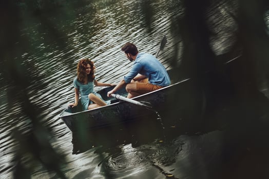 In the perfect place. Beautiful young couple enjoying romantic date while rowing a boat photo