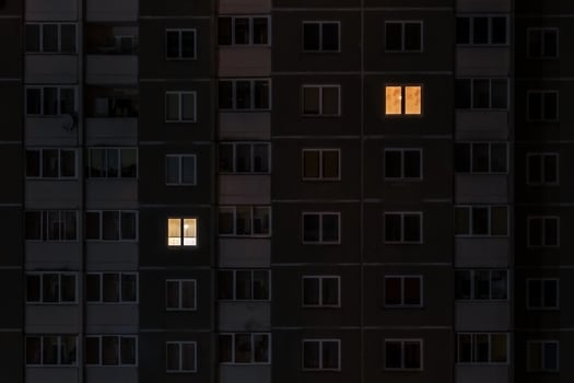 Flat night panorama of light in windows of multistory buildings. life in big city. concept for a couple in love on isolation photo