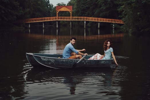 Happy to be in love. Beautiful young couple smiling while enjoying romantic date on the lake photo