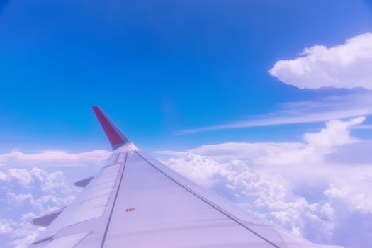 Wing of an airplane above white clouds. photo