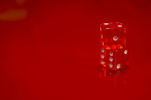 Two Red dice on bright red glossy background. photo