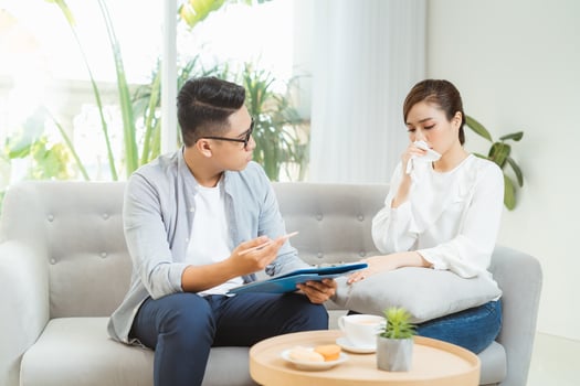 Psychological treatment. Professional psychologist helping his patient while having a session with him. photo