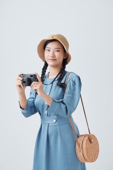 Young cute smiling girl taking pictures on a compact camera photo