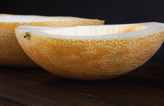 Cut ripe melon on a black background. photo