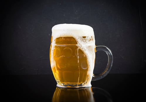 Mug of light beer on dark background. Craft unfiltered beer photo